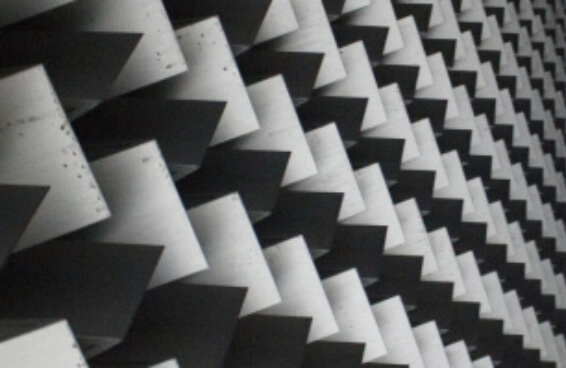 Black and white abstract photo of a textured roof featuring squares in a grid pattern