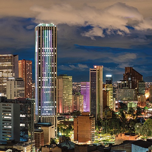 The illuminated Colpatria Tower at night with the Bogotá skyline stretching out in the background