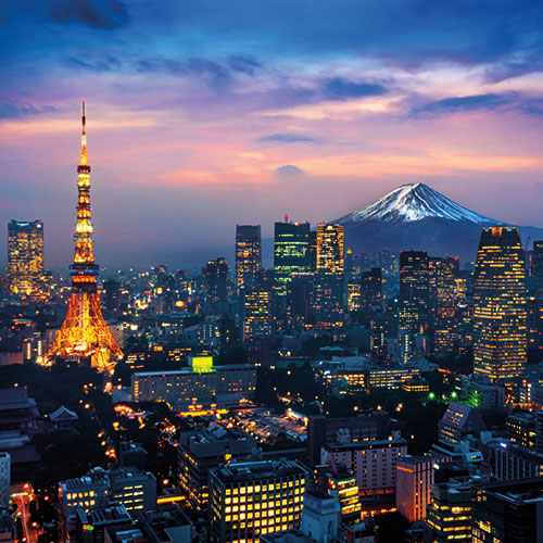 A stunning night shot of Tokyo skyline with illuminated buildings, Tokyo Tower, and Mount Fuji in the background