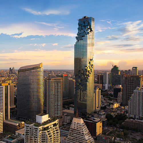 A scenic view of Bangkok skyline at dusk with the iconic MahaNakhon skyscraper