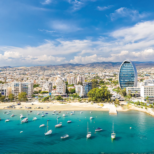 An aerial view of  Limassol Cyprus showing the coastline, marina, and cityscape with a modern high-rise building