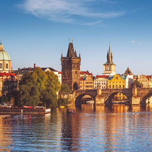 A panoramic view of Prague, Czech Republic, featuring the iconic Charles Bridge and the historic Old Town