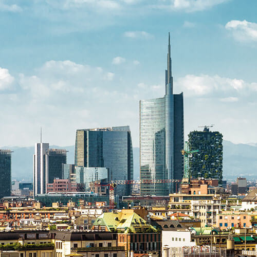 A panoramic view of Milan's skyline, featuring modern skyscrapers like the Torre Unicredit and Bosco Verticale