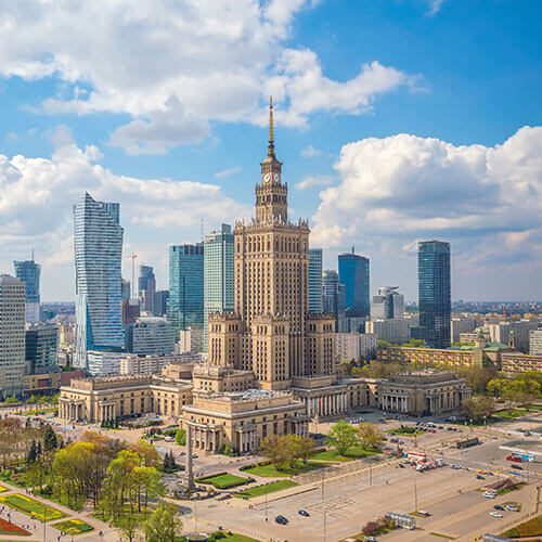 A panoramic view of Warsaw, Poland, featuring the Palace of Culture and Science and the modern city skyline