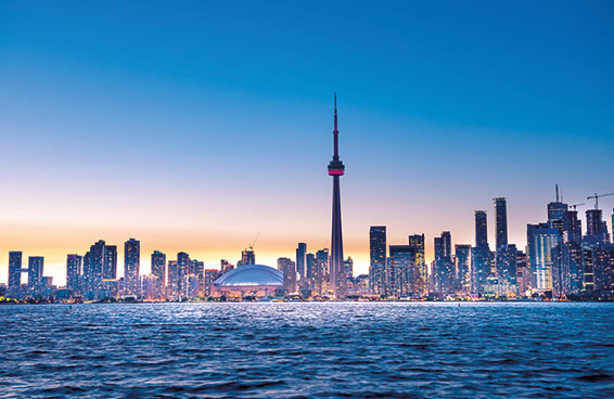 A panoramic view of Toronto skyline at dusk, with the CN Tower illuminated