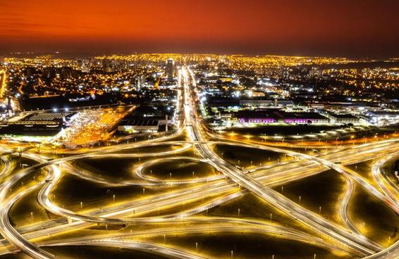 An aerial view of a busy highway interchange in São Paulo, Brazil, at night