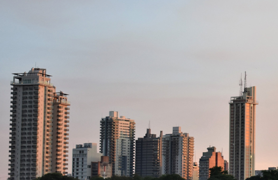 A stunning image of the skyline of Asunción, Paraguay, with tall buildings and a beautiful sunset sky