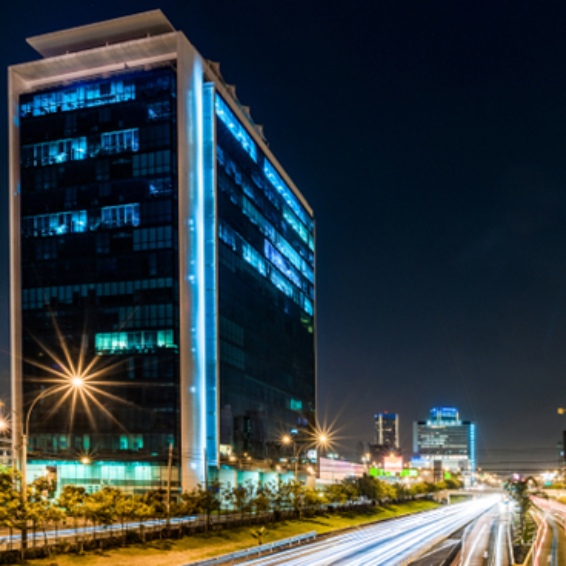 A night shot of a modern corporate building with a busy highway at Lima San Isidro Peru