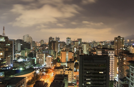 A stunning night shot of skyline of Caracas City, Venezuela with a dense cityscape illuminated