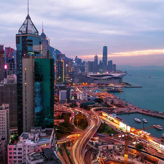 An aerial view of the Hong Kong skyline at dusk, with the iconic Victoria Harbour