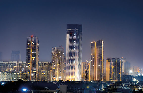 A stunning night shot of the modern skyline of Gurugram and illuminated buildings