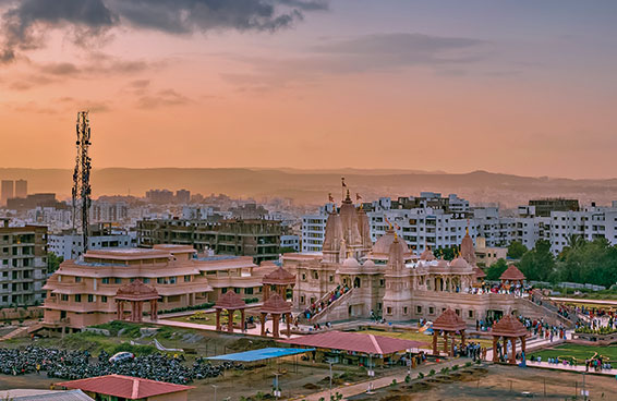 A panoramic view of the Shree Swaminarayan Temple in Pune, India, during sunset