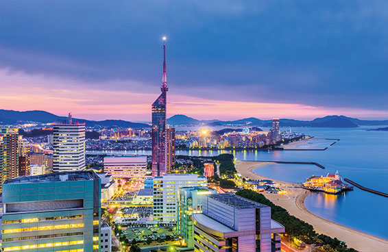 A panoramic view of the Fukuoka skyline at twilight with Fukuoka Tower