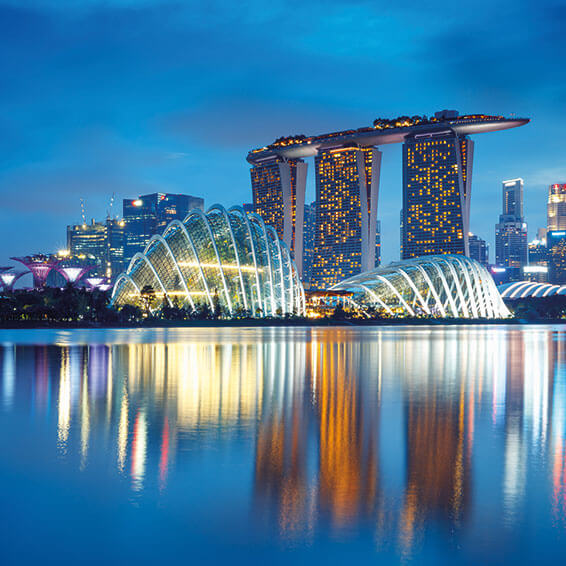 An aerial view of the iconic Marina Bay Sands and Gardens by the Bay at night