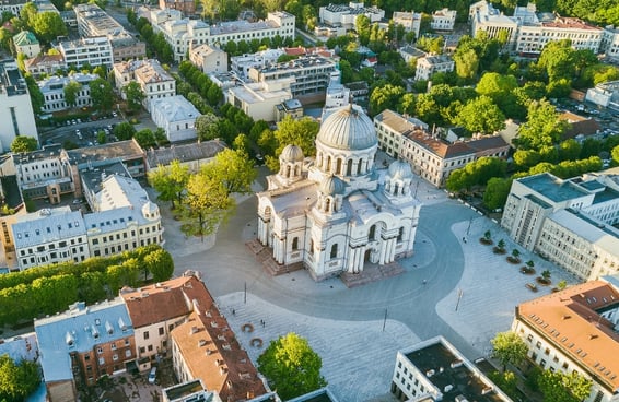 Cathedral and city square in Kaunas, Lithuania, seen from above with surrounding urban landscape.