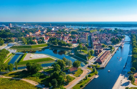 Klaipėda, Lithuania cityscape with canals, historic architecture, and green spaces.
