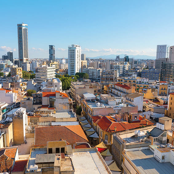 A view of the Nicosia skyline, showing a mix of modern high-rises and older buildings