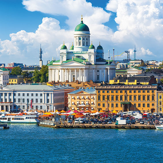 A vibrant photo of the Helsinki Cathedral and Market Square, with the harbor in the foreground