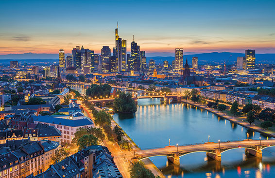 A shot of the Frankfurt skyline at night, with the Main River and several bridges