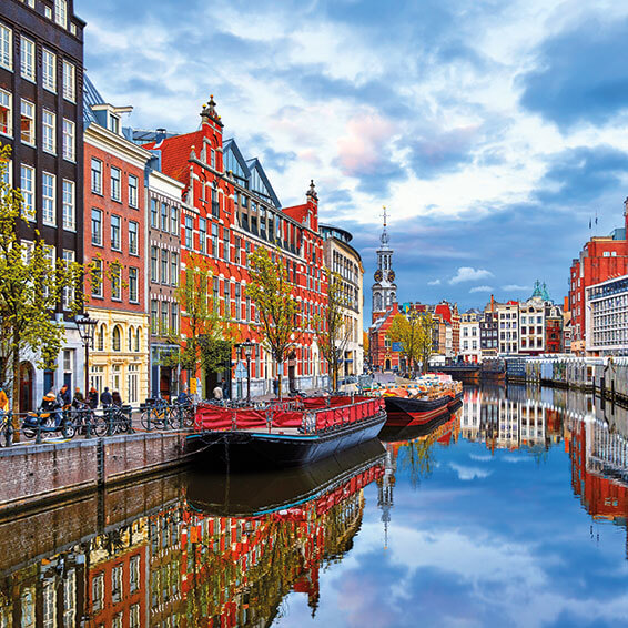 An aerial view of the canal in Amsterdam with colorful houses and boats