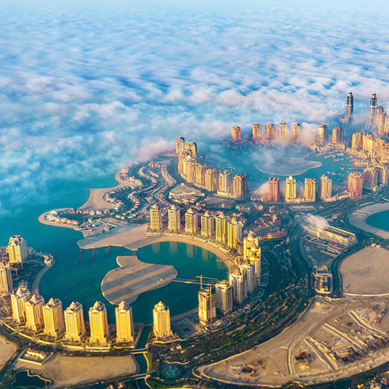 An aerial view of The Pearl-Qatar, an artificial island in Doha, Qatar, with high-rise buildings and waterways