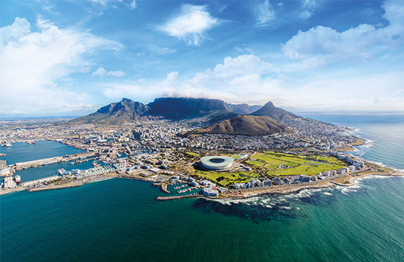 An aerial view of Cape Town, South Africa, showcasing Table Mountain, the city center, and the coastline