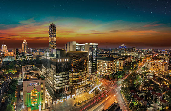 A night view of Sandton, Johannesburg, South Africa, with the skyline illuminated and traffic moving on the roads