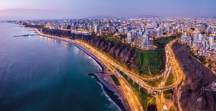 An aerial view of Lima Peru highlighting the city's coastal location and the beautiful Pacific Ocean