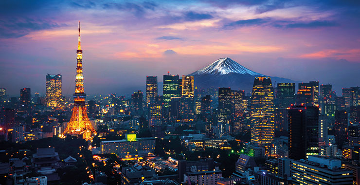 A stunning night shot of Tokyo skyline with illuminated buildings, Tokyo Tower, and Mount Fuji in the background