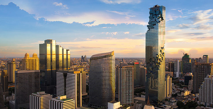 A scenic view of Bangkok skyline at dusk with the iconic MahaNakhon skyscraper