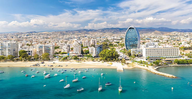 An aerial view of  Limassol Cyprus showing the coastline, marina, and cityscape with a modern high-rise building