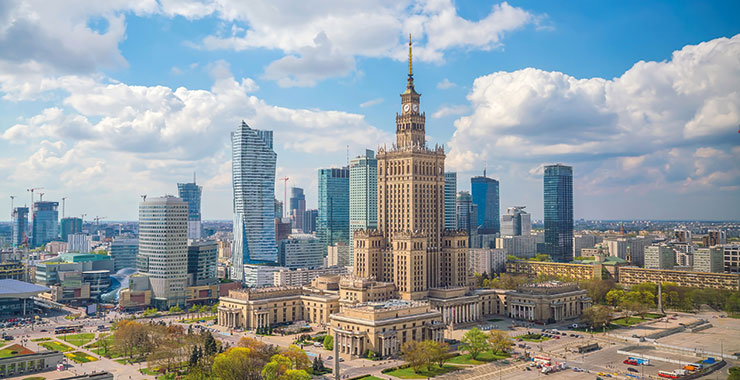 A panoramic view of Warsaw, Poland, featuring the Palace of Culture and Science and the modern city skyline