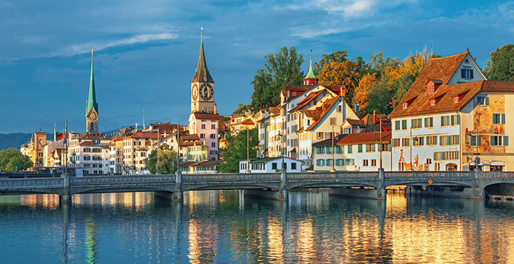 A panoramic view of Zurich, Switzerland, with the Limmat River, Fraumünster Church, and Grossmünster Church