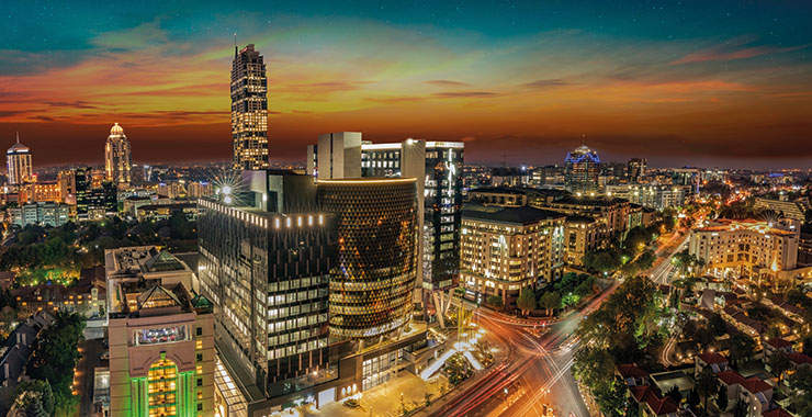 A stunning night shot of Sandton, Johannesburg, South Africa, showcasing the city's modern skyline and illuminated streets