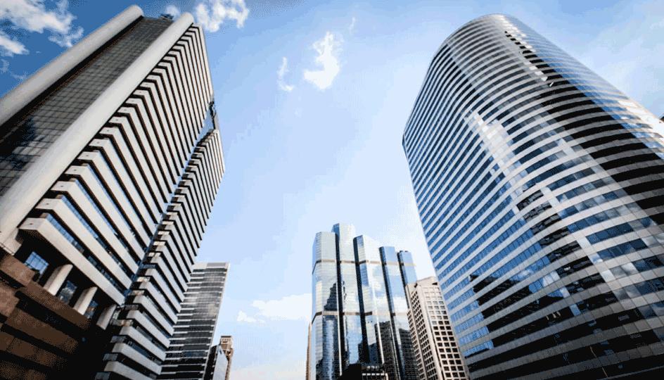 A low-angle view of several tall, modern skyscrapers in a city