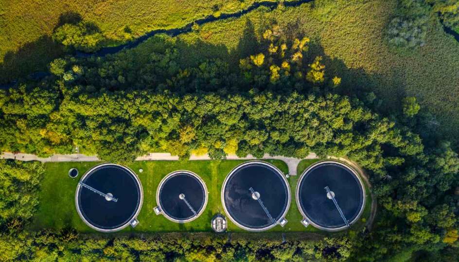 A wastewater treatment plant surrounded by greenery, demonstrating sustainable environmental practices